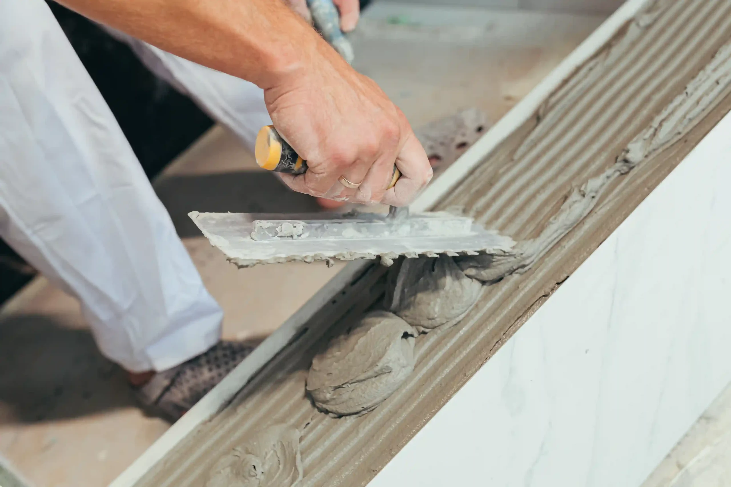 male-worker-professional-mounts-ceramic-tile-in-ba-2025-03-26-18-03-03-utc