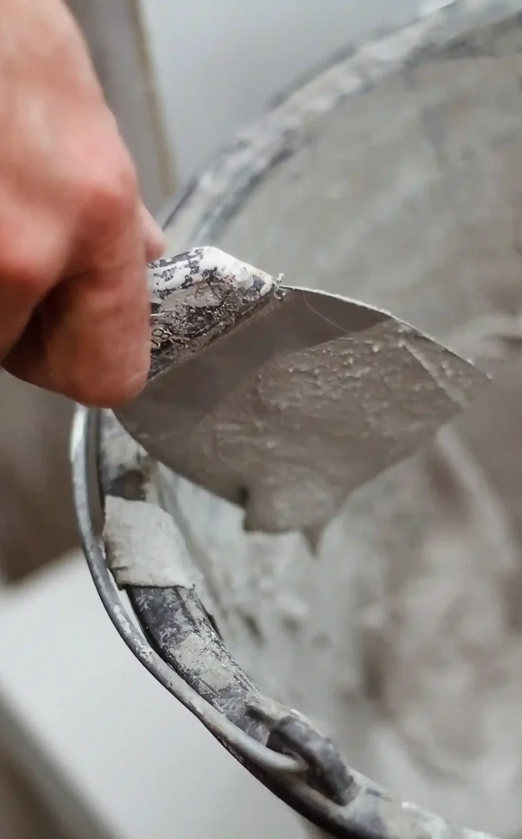 man-s-hand-picks-up-plaster-on-a-spatul-2025-01-08-02-51-19-utc