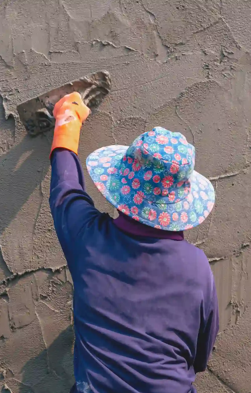 rear-view-of-female-construction-laborer-using-tro-2025-03-10-19-42-10-utc